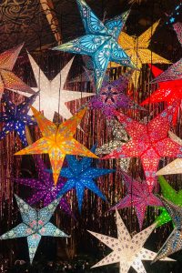 Starry-themed bedroom with celestial wall décor and glowing LED lights