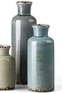 “CwlwGO ceramic vase 3-piece set on a wooden table with flower arrangements in a cozy living room.”