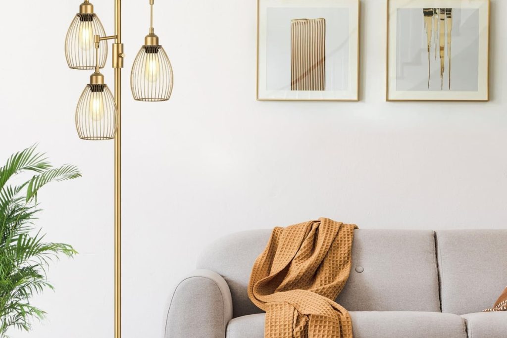 Elegant gold floor lamp with three teardrop cage light heads