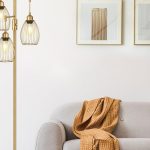 Elegant gold floor lamp with three teardrop cage light heads