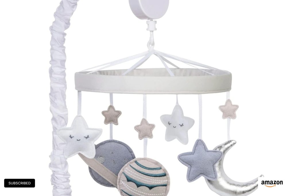 Soft plush celestial-themed baby crib mobile with stars and planets, plays soothing lullabies to calm newborns, Trend Lab nursery accessory.