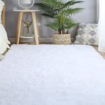 White CAIYUECS Ultra Soft Shag Area Rug in cozy living room setting