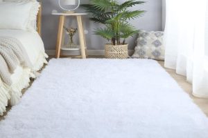 White CAIYUECS Ultra Soft Shag Area Rug in cozy living room setting