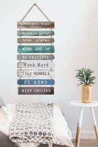 “12x24 rustic wooden inspirational wall art sign with motivational quotes hanging on an office wall.”