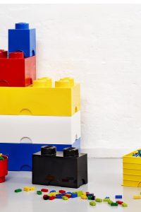 “Room Copenhagen LEGO Brick 8 stackable plastic storage box in medium azure color, shown on a shelf in a kids' room.”