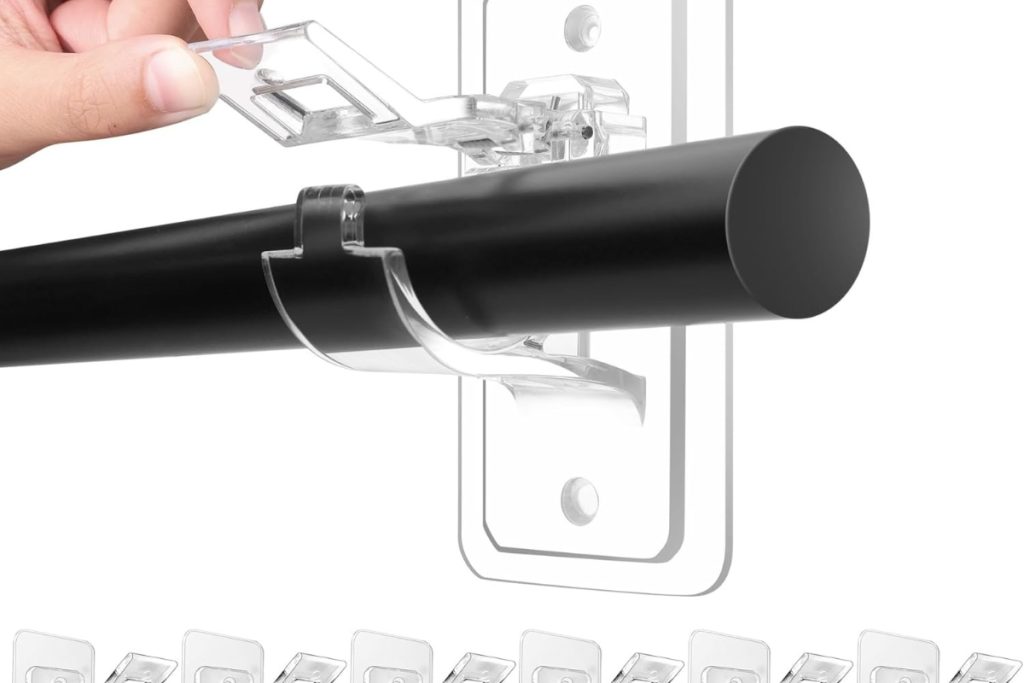 “No drill adhesive curtain rod holders in use on a living room wall – damage-free setup”