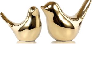 Gold bird figurine decor by FANTESTICRYAN on a modern shelf – elegant home accent piece