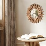 Honiway 12 inch Rustic Wood Sunburst Wall Mirror in Carbonized Black hanging on a cozy living room wall.