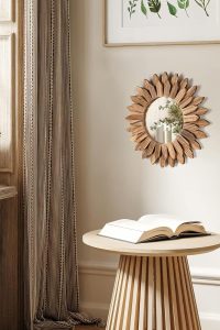 Honiway 12 inch Rustic Wood Sunburst Wall Mirror in Carbonized Black hanging on a cozy living room wall.