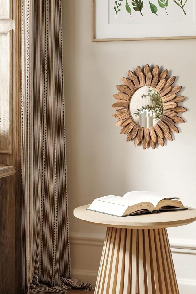 Honiway 12 inch Rustic Wood Sunburst Wall Mirror in Carbonized Black hanging on a cozy living room wall.