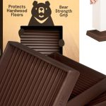 Set of 4 brown rubber square caster cups by CasterMaster placed under furniture legs on a hardwood floor.