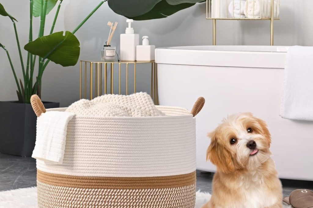 KAKAMAY Large Blanket Basket in white and brown cotton rope, perfect for baby laundry, pillows, or toys, placed in a cozy living room corner.