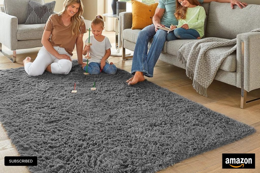 Soft grey fluffy Ophanie shag area rug in a cozy bedroom setting