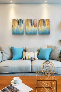 3-piece golden leaves canvas wall art displayed in a modern bedroom above the bed