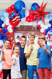 "Red, white, and blue balloon arch with silver star foil balloons for 4th of July patriotic party decoration"