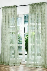 Kotile sage green sheer curtains with rustic floral lace pattern, 102 inches long, 2 panels hung in a bright vintage-style living room with soft natural light.
