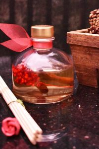 LOVSPA holiday reed diffuser set with spiced red currant, pine, cranberry, cedarwood, and juniper scents – festive home fragrance made in the USA.