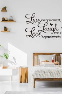 "Inspirational wall sticker with the quote 'Live Every Moment, Laugh Every Day, Love Beyond Words' in elegant black script font for family home decor"