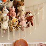 “Corner toy hammock holding stuffed animals in kids bedroom” “Large stuffed animal net for wall-mounted toy storage”