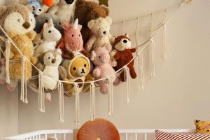 “Corner toy hammock holding stuffed animals in kids bedroom”“Large stuffed animal net for wall-mounted toy storage”