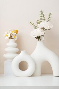 Set of 3 white ceramic vases in different shapes, styled in a modern boho living room.