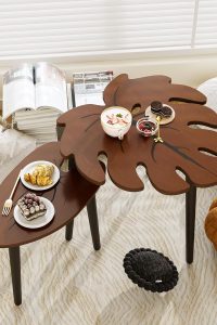 "BAMEOS set of 2 monstera leaf nesting tables with modern wooden tops and leaf vein pattern, perfect for living room, bedroom, balcony, or yard"