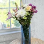 "Elegant blue glass flower vase with modern design, ideal for home decor in the living room, bedroom, dining table, or office space."