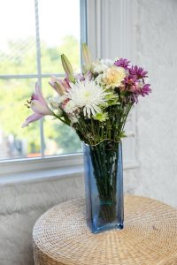 "Elegant blue glass flower vase with modern design, ideal for home decor in the living room, bedroom, dining table, or office space."