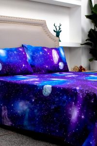 Purple galaxy-themed sheet set with stars and space design on full bed