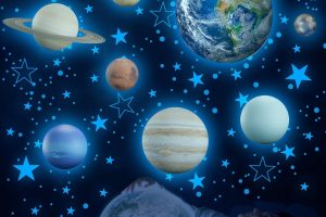 Glow in the dark stars and planets wall decals on blue bedroom ceiling