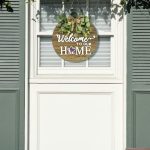 Rustic round wooden interchangeable welcome sign for front door, with seasonal icons for spring, summer, fall, and winter