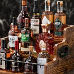 "KLM 3-tier liquor bottle display shelf on a kitchen countertop with whiskey and wine bottles"