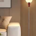 Red modern floor lamp with frosted globe shade and slim metal frame