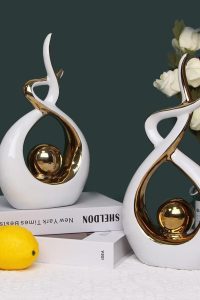 Small white and gold modern abstract ceramic statue by Norrclp – decorative table sculpture for dining room, living room, or office centerpiece