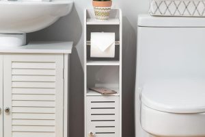 White AOJEZOR toilet paper holder stand with built-in slim bathroom storage cabinet, ideal for small spaces beside the toilet