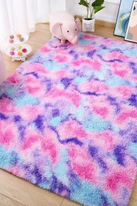 Soft and fluffy 3x5 rainbow area rug in hot pink and pastel colors, perfect for girls' bedroom or nursery decor.