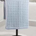 "T-Shape stainless steel towel rack on bathroom counter holding hand towels"