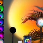 "Sunset lamp projector LED light casting rainbow RGB colors on bedroom wall – 360 degree rotating night light for aesthetic room decor"
