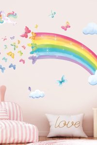 Rainbow unicorn wall decals on a baby girl's nursery wall