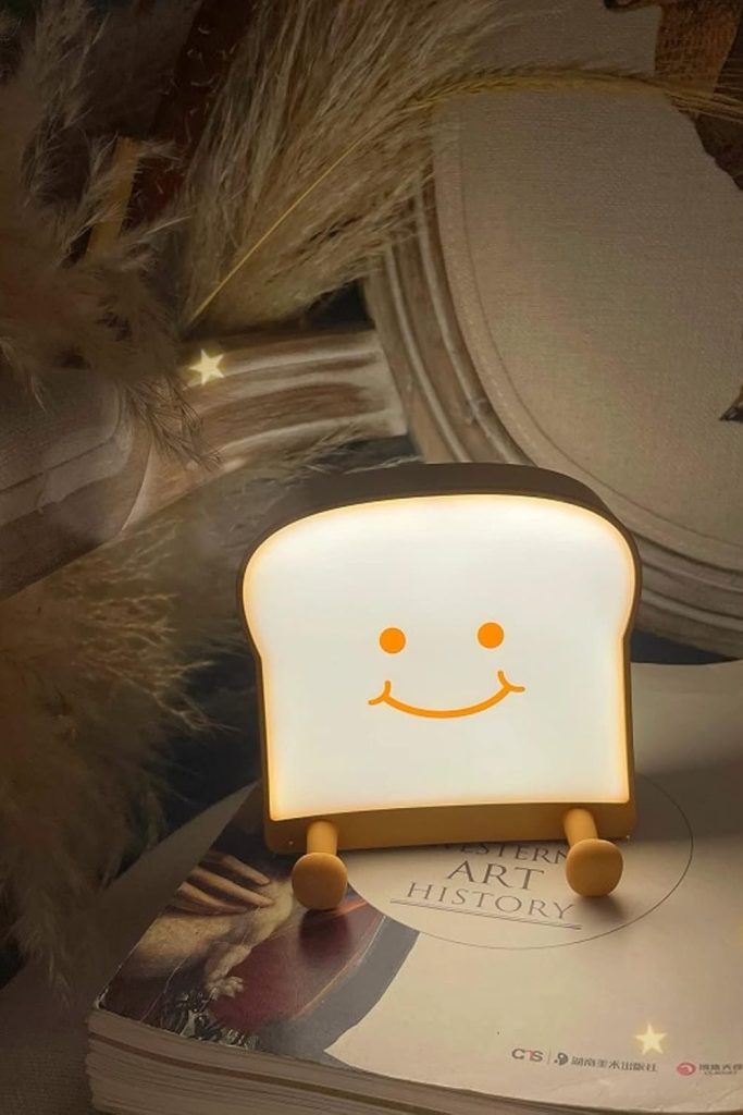 QANYI toast bread night light with smiling face on a teen girl’s nightstand