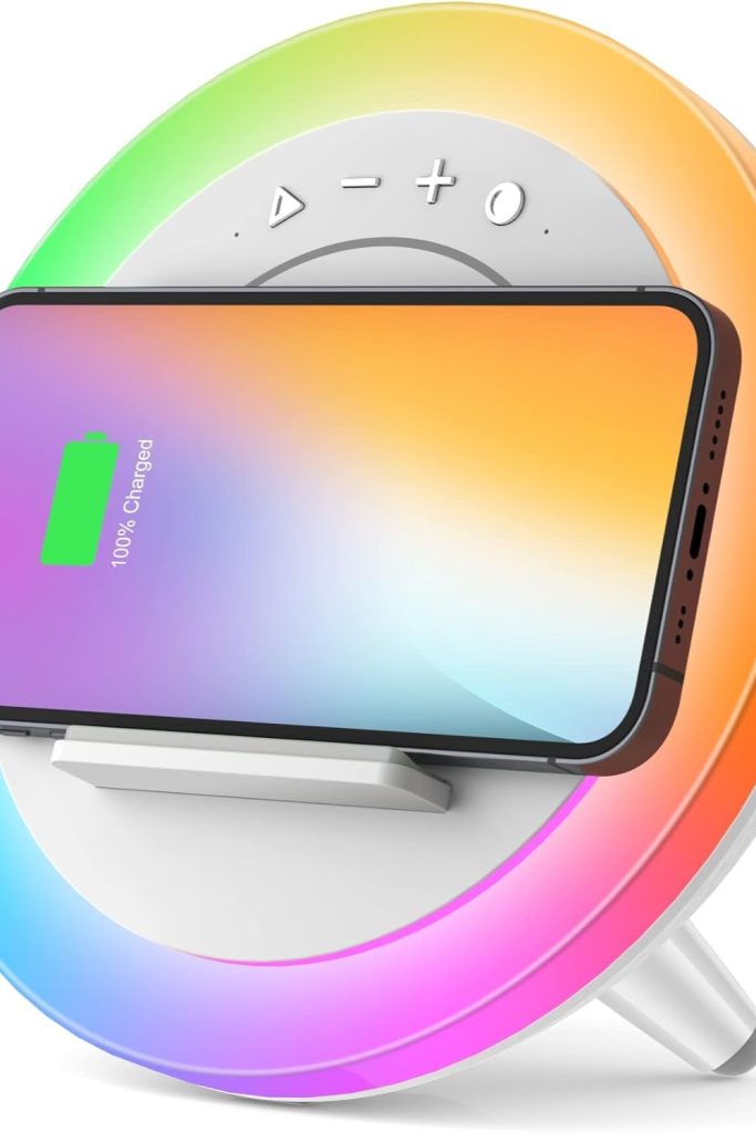 Bluetooth speaker with LED lights and wireless charging pad on a teen girl’s nightstand
