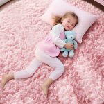 Ophanie pink shag round area rug 4ft placed in bedroom