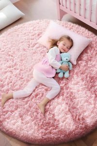 Ophanie pink shag round area rug 4ft placed in bedroom