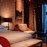 USB Star Projector Night Light with flexible gooseneck, projecting red LED stars in car interior