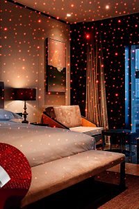 USB Star Projector Night Light with flexible gooseneck, projecting red LED stars in car interior