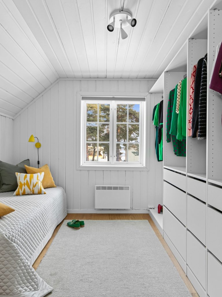 "Bright small living room with mirrors and neutral walls to make it look bigger"