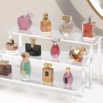 3-tier acrylic display risers showcasing perfumes and collectibles