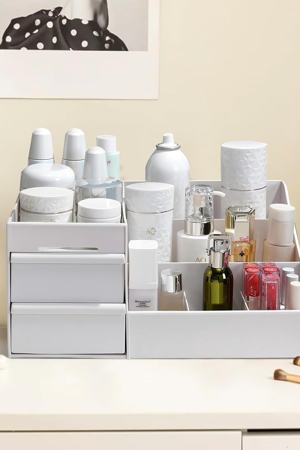 Large makeup organizer with drawers on vanity holding cosmetics and brushes