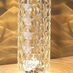 “Portable rose crystal table lamp glowing with warm light on bedside table”