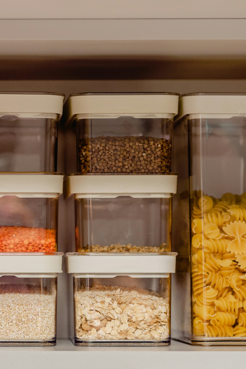 Clear containers neatly organizing dry goods in pantry